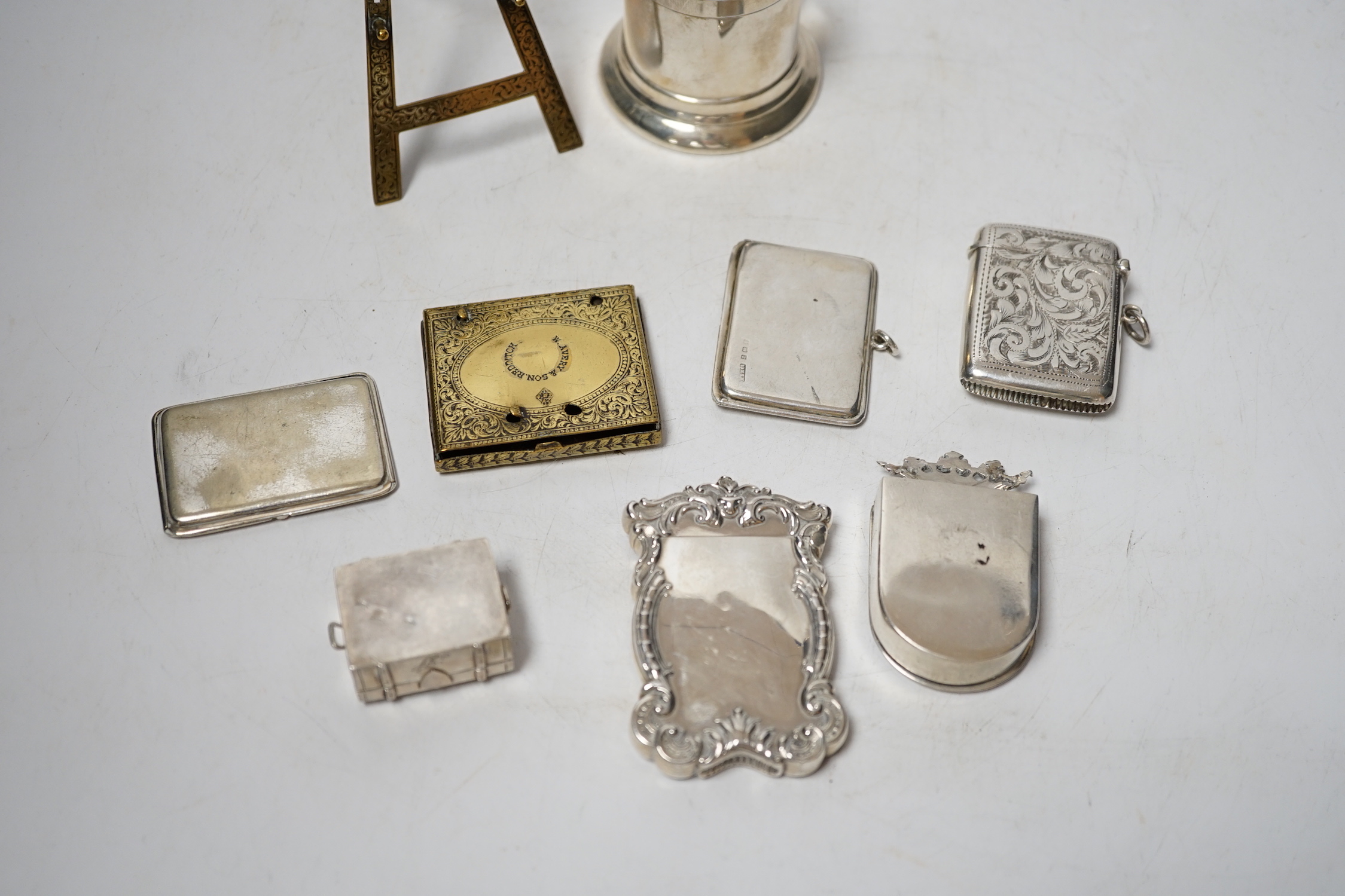 An Edwardian engraved silver combination stamp box/vesta case, Birmingham, 1906, 48mm, a similar silver slide action stamp case and seven other items including white metal box and sterling dispenser, etc.